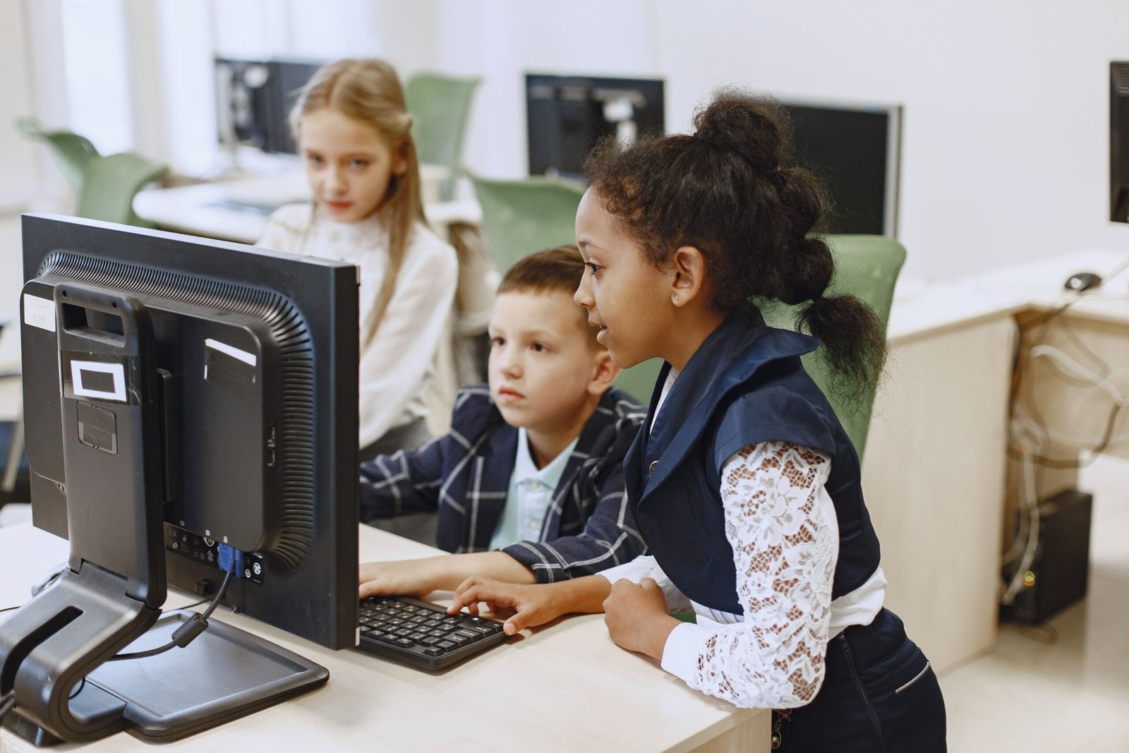 Children learning digital skills on a computer